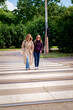 © sepy - A visually impaired woman crossing the pedestrian crossing with her female friend