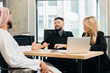 © dsheremeta - Business colleagues collaborating on strategy in modern office