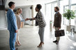 © Zoran Jesic - Business colleagues shaking hands during corporate meeting in office building