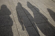 © AnnaNovaCreate - Shadows of People on City Pavement in Sunlight