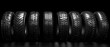 © COK House - An array of tyres on a black background with dramatic lighting.Ideal for advertising tyres, car services, articles on choosing car tyres, and auto parts catalogues.