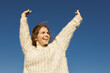 © Anna - freedom-loving, happy young European woman in her 20s enjoying a moment outdoors on a sunny day against a cloudless sky. Love life, well-being, positive thinking.