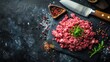 © Suphawan - Raw minced beef and pork arranged artistically on dark stone with butcher knife and spices, creating professional food styling look