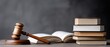 © lililia - A gavel is placed on a sound block beside a stack of law books, creating a serious atmosphere in a legal office filled with knowledge