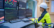 © reewungjunerr - Engineer working at control room, Manager control system, Technician man monitoring program from a lot of monitor.Specialist observes analytics dashboard,operator inspects digital interface
