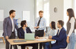 © Studio Romantic - Male confident leader talking to diverse business team during meeting in modern office interior, talking, working on new project together, brainstorming, listening to boss, starting working together
