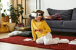 © Bliss - Girl enjoys virtual reality experience in cozy home setting with casual attire