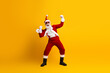 © deagreez - Cheerful Santa Claus in a festive celebration pose against a vibrant yellow background, embodying Christmas magic and holiday spirit