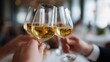 © Jaroon - Toast of Celebration: Three crystal glasses of effervescent, golden wine are raised in a celebratory toast, showcasing a moment of camaraderie and shared joy. A sensory experience of clinking glasses.