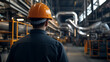 © photo for everything - An engineer wearing safety helmet inspecting a factory. He's checking the pipes and other infrastructure. He is focused on his duties to ensure the security of factory.