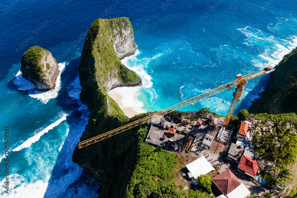 Large construction crane on cliff overlooking iconic Kelingking Beach ...