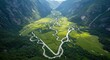 © Ariestia - Elevated view captures serpentine river winding through a lush, steep-sided mountain valley