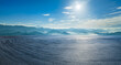 © ABCDstock - Empty asphalt race track with tire tracks and green mountain natural landscape in the morning
