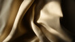 © photo for everything - Golden fabric cascades in soft folds, shadowed depths enhancing its velvety texture. Light dances, creating a tactile, comforting scene. Luxury and serenity intertwined.