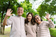 © DG PhotoStock - Asian family living together in park showing love, relationship and bonding.