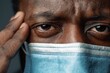 © Vlad - Health Disparity: African American Man Wearing Blue and White Surgical Face Mask