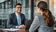 © Rifqi - Smiling businessman in suit using laptop during meeting with female colleague in office. Concept for recruitment interview, performance appraisal and company growth