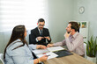 © AntonioDiaz - Lawyer conciliating couple discussing divorce agreement paperwork