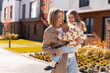 © Maria Vitkovska - Mother carrying daughter smiling during autumn walk outdoors