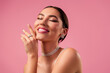 © Beauty Hero - Beautiful young woman with stunning jewelry and glamorous makeup posing against a soft pink background