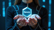 © NARUMOL - Person holding transparent hexagonal shape with word Secure displayed, surrounded by digital background with blue lights, symbolizing