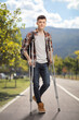 © Ljupco Smokovski - Male student with crutches standing in a park