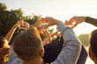 © Studio Romantic - People making heart shape gesture with fingers in sunshine, back view. Crowd of happy young friends showing love and gratitude to nature, greeting summer sun and freedom. Community, hope concept
