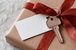 © Iryna - Gift wrapped present with a key and blank tag for special occasions