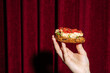 © Pietro Karras/Stocksy - Hand presenting tomato toast with creamy topping