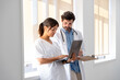 © Santi Nuñez/Stocksy - Doctor and nurse discussing patient information using laptop