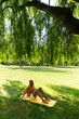 © Mattia/Stocksy - Balck Man Seated under a Willow tree on top of a Yellow Yoga Mat
