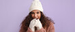 © Pixel-Shot - Pretty African-American woman in winter clothes warming her hands on color background