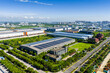 © Yic Ma/Stocksy - Aerial view of modern industrial park with solar panel rooftops