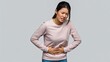 © Navee - Woman suffering from stomach pain and discomfort on gray background