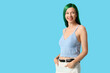 © Pixel-Shot - Pretty young woman with green hair on blue background