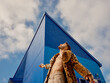 © Iryna Shepetko/Stocksy - Man Posing Confidently in Stylish Coat Against Blue Wall