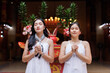 © crizzystudio - Two asian women quietly praying in a temple