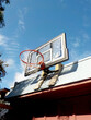 © Erik Naumann/Stocksy - Alley basketball net mounted on a garage on a sunny day