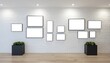 © Danish - a wall full of empty white frames, minimal modern decor, hardwood floors, potted plants, bright and airy room interior, simple clean aesthetic, minimal art gallery display, modern