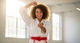 Smiling woman in karate uniform celebrates a martial arts victory