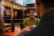 © Westend61 - Friends talking and smiling at brewery bar with drinks in evening