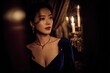 © zenith - Luxurious portrait of elegant woman in deep sapphire velvet dress with candlelight and golden jewelry