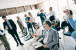 © deagreez - Diverse business team celebrates success with a toast during a corporate meeting in a bright office environment