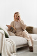 © Bliss - Blonde woman enjoying a cozy afternoon at home in a modern apartment