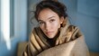 © forenna - A person wrapping themselves in a blanket near an indoor heater, symbolizing coziness, relaxation, and home well-being on a cold day. cinematic color correction, natural uneven lighting yet gentle