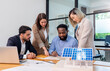 © PINA - team of multiethnic coworker meeting on solar roof system project with solar panel house model, responsibility of green industry alternative renewable clean environment energy for sustainable business