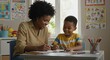 © Sandor - smiling african american woman teaching young boy writing skills in classroom setting