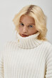 © LIGHTFIELD STUDIOS - Cozy winter vibes from a beautiful blonde woman in a knitted sweater