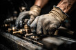 © Kowit - The image shows a close-up of hands in gloves working on machinery, emphasizing craftsmanship and industrial work.