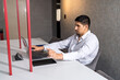 © Guillermo Spelucin - Man attending customer at office desk using laptop